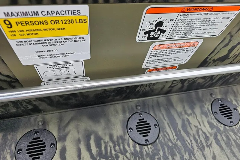 Slide: The Image of 2026 Tracker Grizzly 2072 CC boat capacity and safety warning labels. - 17