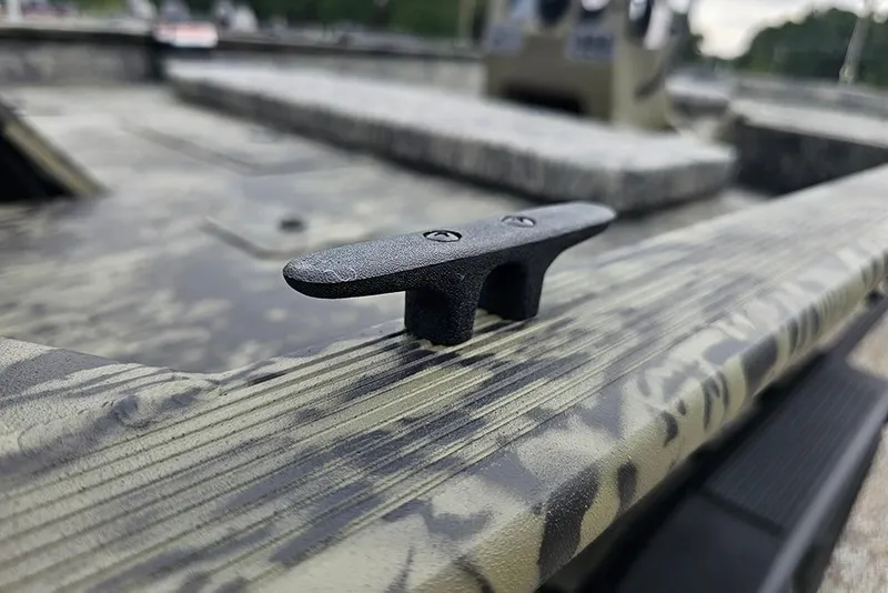 Slide: The Image of 2026 Tracker Grizzly 2072 CC boat cleat on camo-patterned deck. - 18