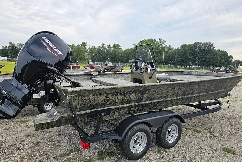 Slide: The Image of 2026 Tracker Grizzly 2072 CC boat with Mercury engine on trailer, parked outdoors. - 7