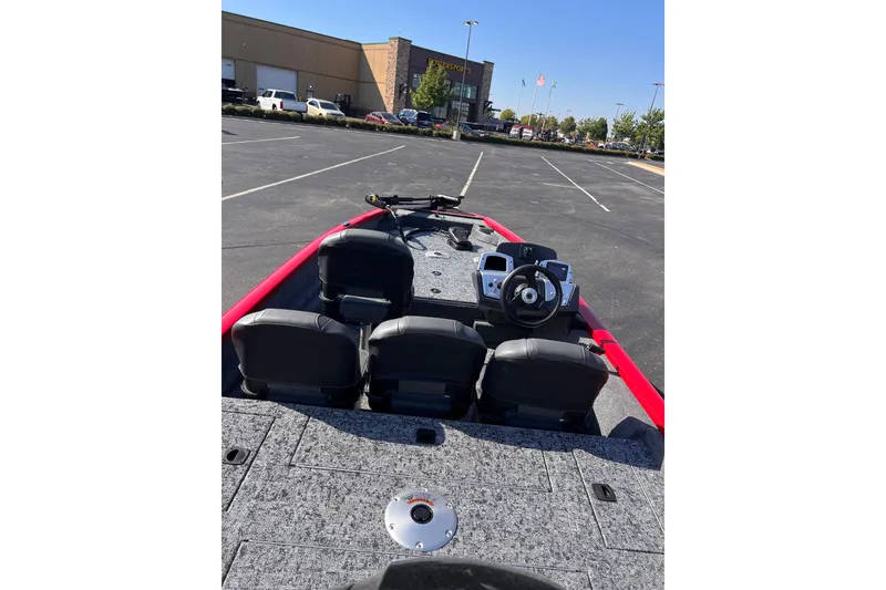 Slide: The Image of 2026 Tracker Pro Team 175 Crappie Edition boat in parking lot, featuring steering wheel and seats. - 5