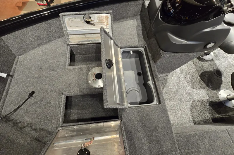 Slide: The Image of 2026 Tracker Super Guide V-16 SC boat interior with open storage compartments. - 47
