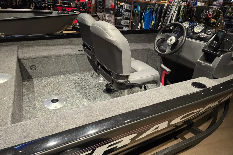 Slide: The Image of 2026 Tracker Super Guide V-16 SC boat interior with steering console and seating. - 46