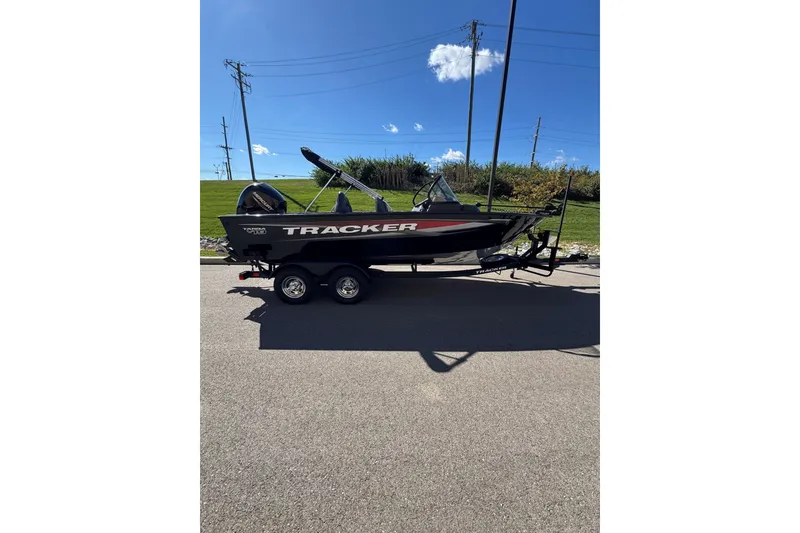 The Image of 2026 Tracker Targa V-19 Combo boat on trailer under clear blue sky. - 1