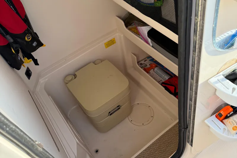 Slide: The Image of Interior of 2017 Grady White 257 Fisherman boat with storage and portable toilet. - 11