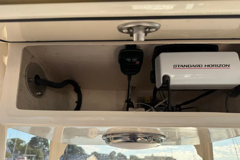 Slide: The Image of 2017 Grady White 257 Fisherman boat electronics compartment with Standard Horizon equipment. - 13