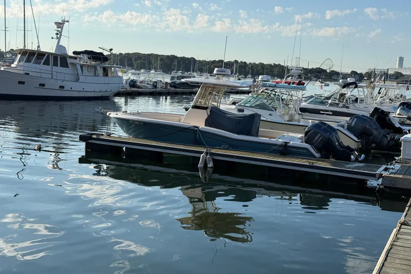 Slide: The Image of 2017 Grady White 257 Fisherman boat docked in a marina with other vessels. - 4