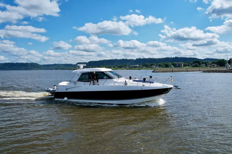 Slide: The Image of 2012 Cruisers Yachts 48 Cantius cruising on a sunny day with scenic shoreline. - 3