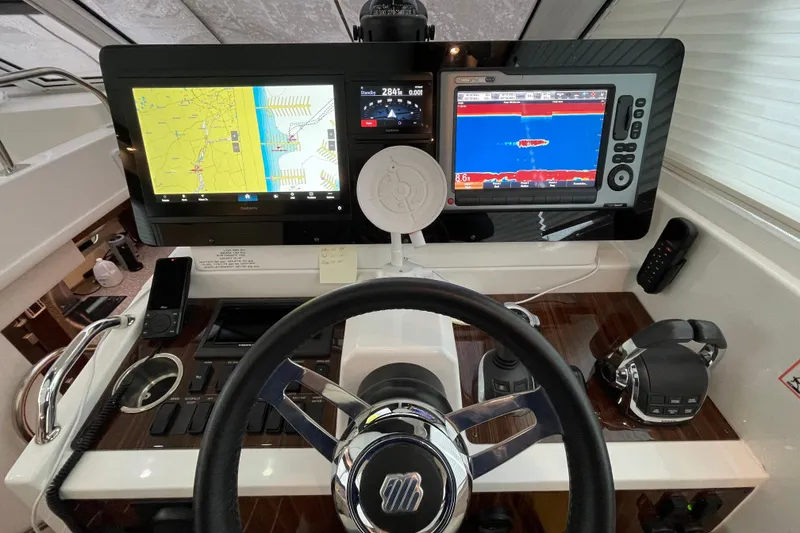 Slide: The Image of Interior helm of 2012 Cruisers Yachts 48 Cantius with modern controls and seating. - 30