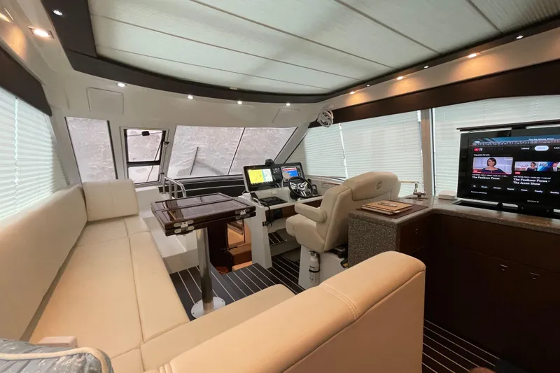 Slide: The Image of Helm of 2012 Cruisers Yachts 48 Cantius with navigation screens and controls. - 34