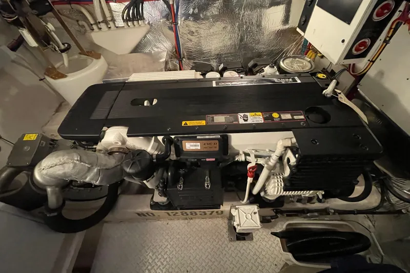 Slide: The Image of Engine room of 2012 Cruisers Yachts 48 Cantius, showcasing mechanical components and wiring. - 62