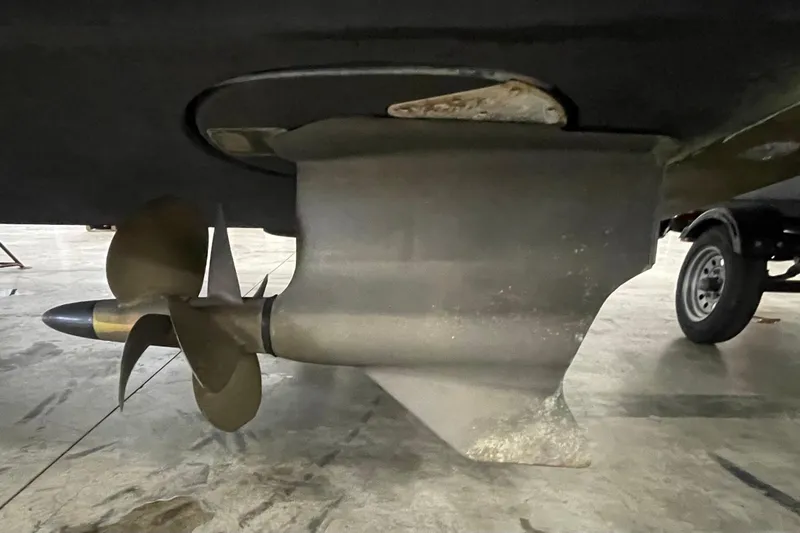 Slide: The Image of 2012 Cruisers Yachts 48 Cantius propeller and rudder detail in a garage setting. - 73