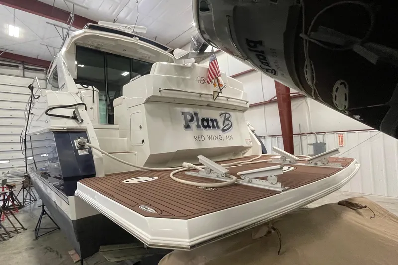 Slide: The Image of 2012 Cruisers Yachts 48 Cantius in storage, rear view with wooden deck. - 76