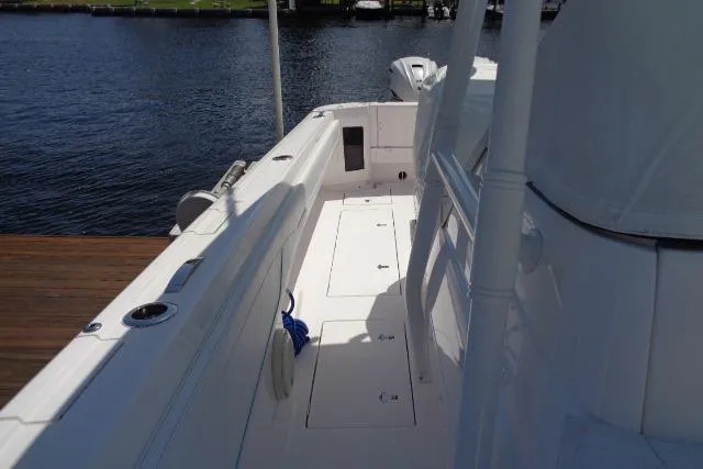 Slide: The Image of 2020 Intrepid 345 Nomad FE boat docked by the water. - 10