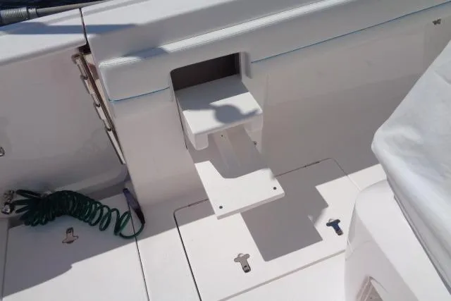 Slide: The Image of 2020 Intrepid 345 Nomad FE boat deck with retractable step and coiled rope. - 15