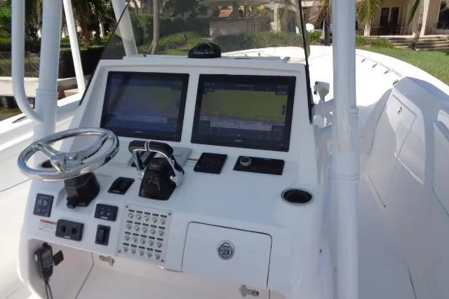 Slide: The Image of 2020 Intrepid 345 Nomad FE boat dashboard with dual navigation screens and controls. - 19