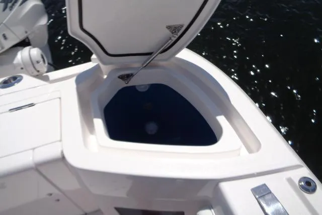 Slide: The Image of Open storage compartment on a 2020 Intrepid 345 Nomad FE boat, near water. - 25