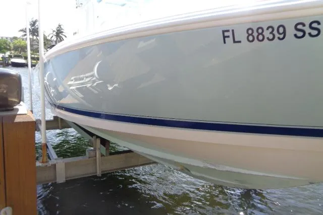 Slide: The Image of 2020 Intrepid 345 Nomad FE boat docked, displaying registration number FL 8839 SS. - 31