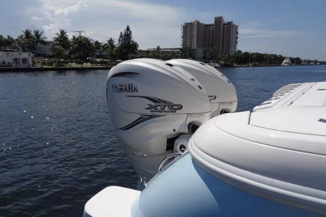 Slide: The Image of 2020 Intrepid 345 Nomad FE with Yamaha XTO engines on a sunny waterfront. - 6