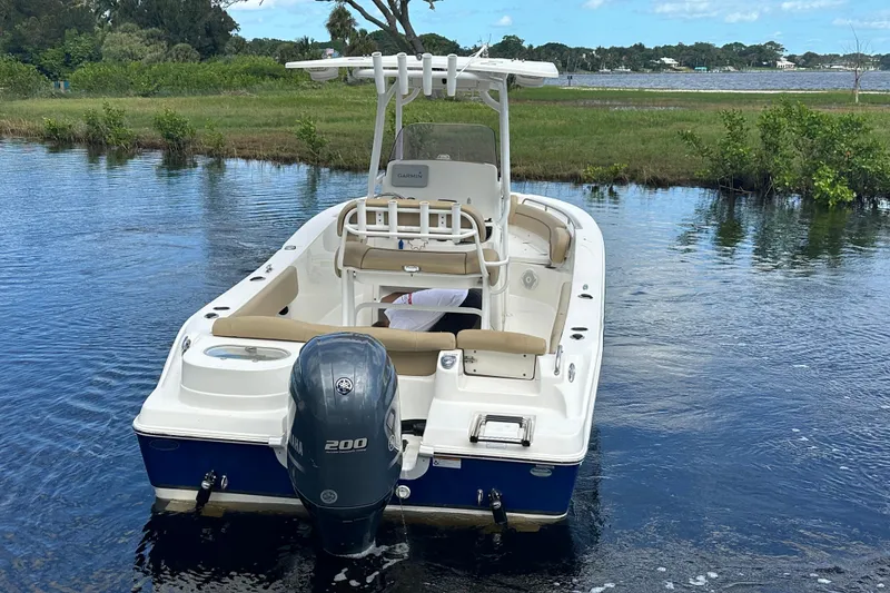 Slide: The Image of 2019 NauticStar 2302 Legacy boat with Yamaha 200 engine on calm water. - 2