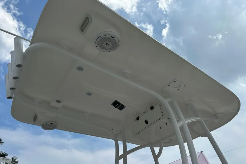 Slide: The Image of 2019 NauticStar 2302 Legacy boat T-top against a cloudy sky. - 7