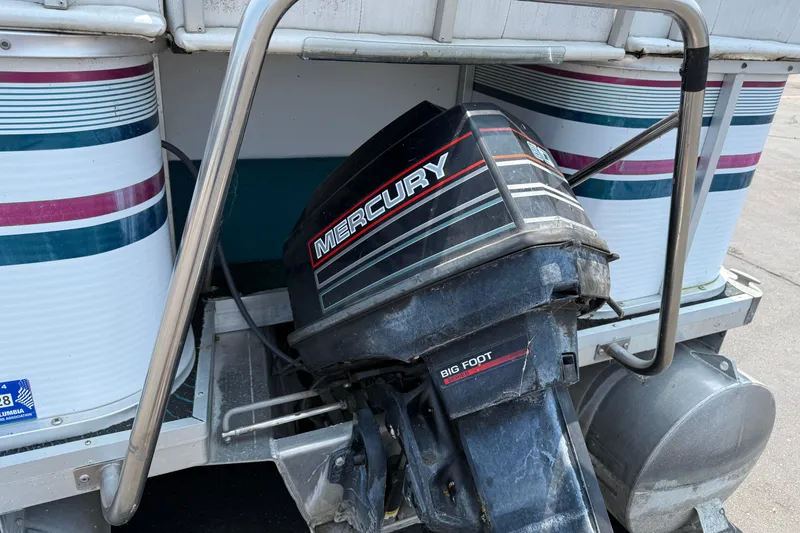 Slide: The Image of 1995 AquaPatio 24 boat with Mercury Bigfoot outboard motor, docked and ready. - 6