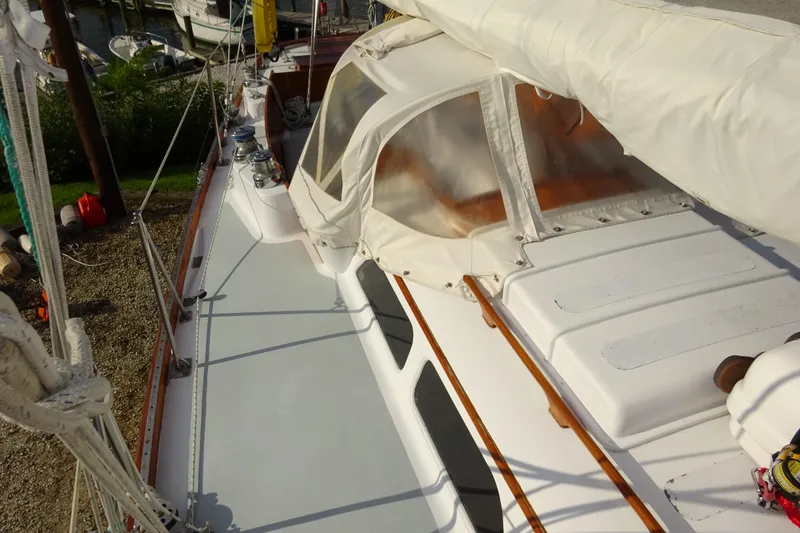 Slide: The Image of 1970 Hinckley Bermuda 40 Custom sailboat deck with white canopy and winches. - 12