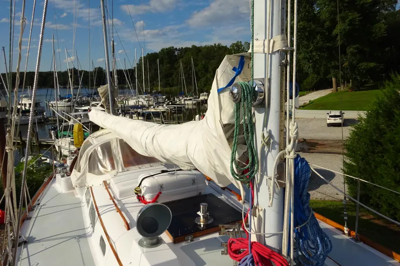 Slide: The Image of 1970 Hinckley Bermuda 40 Custom sailboat docked, with rigging and covered sails. - 21