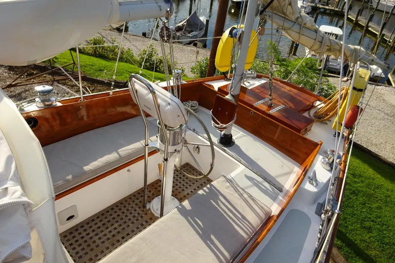 Slide: The Image of 1970 Hinckley Bermuda 40 Custom sailboat cockpit with wooden accents and marina view. - 28