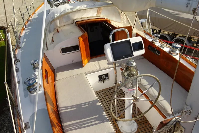 Slide: The Image of 1970 Hinckley Bermuda 40 Custom sailboat cockpit with wooden accents and navigation equipment. - 36