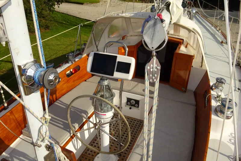 Slide: The Image of 1970 Hinckley Bermuda 40 Custom sailboat cockpit with wooden accents and steering wheel. - 37