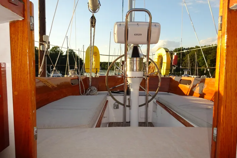 Slide: The Image of Cockpit of 1970 Hinckley Bermuda 40 Custom sailboat with wooden finish and steering wheel. - 43