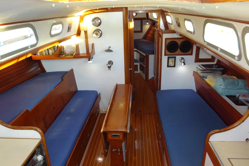 Slide: The Image of Interior of 1970 Hinckley Bermuda 40 Custom sailboat with wooden finishes and blue seating. - 44