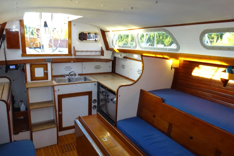 Slide: The Image of Interior of 1970 Hinckley Bermuda 40 Custom sailboat with wooden finishes and blue seating. - 55