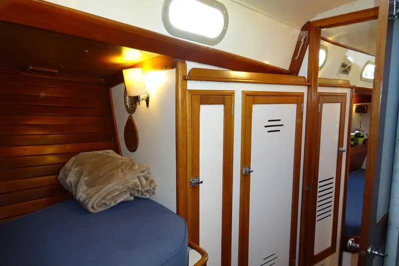 Slide: The Image of Interior of 1970 Hinckley Bermuda 40 Custom yacht with wooden paneling and cozy bedding. - 59
