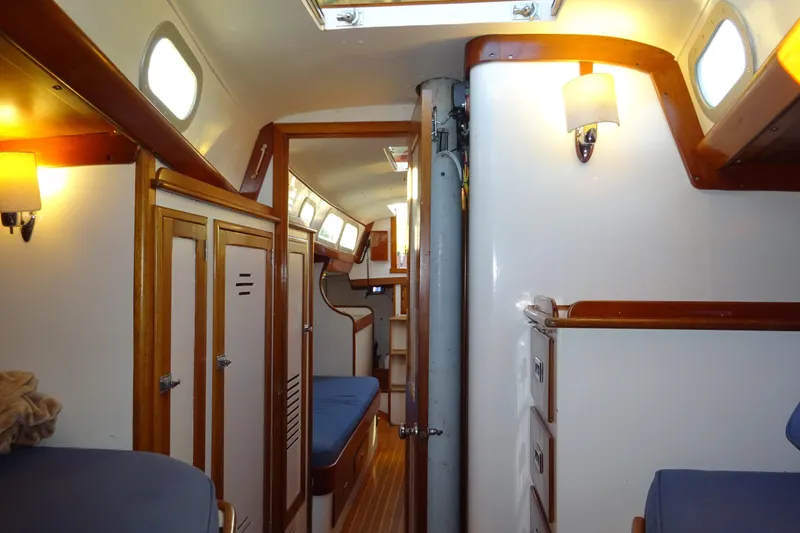 Slide: The Image of Interior of 1970 Hinckley Bermuda 40 Custom sailboat with wooden accents and cozy seating. - 60