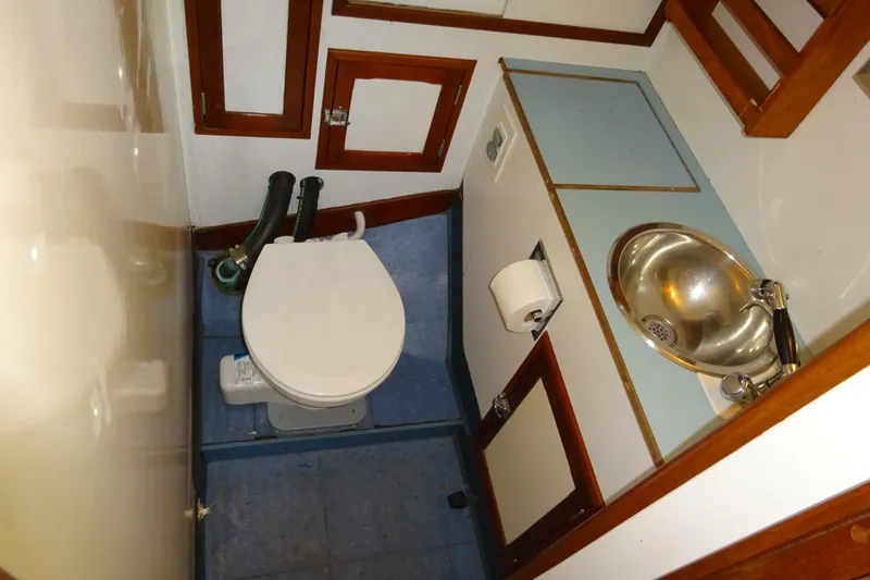 Slide: The Image of 1970 Hinckley Bermuda 40 Custom yacht bathroom with toilet and stainless steel sink. - 63