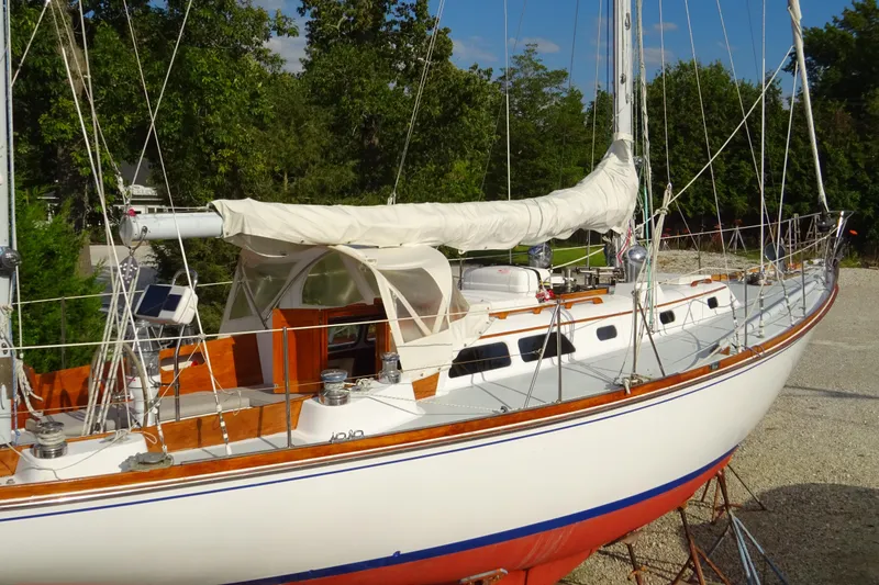 Slide: The Image of 1970 Hinckley Bermuda 40 Custom sailboat on land, featuring classic design and wooden accents. - 7