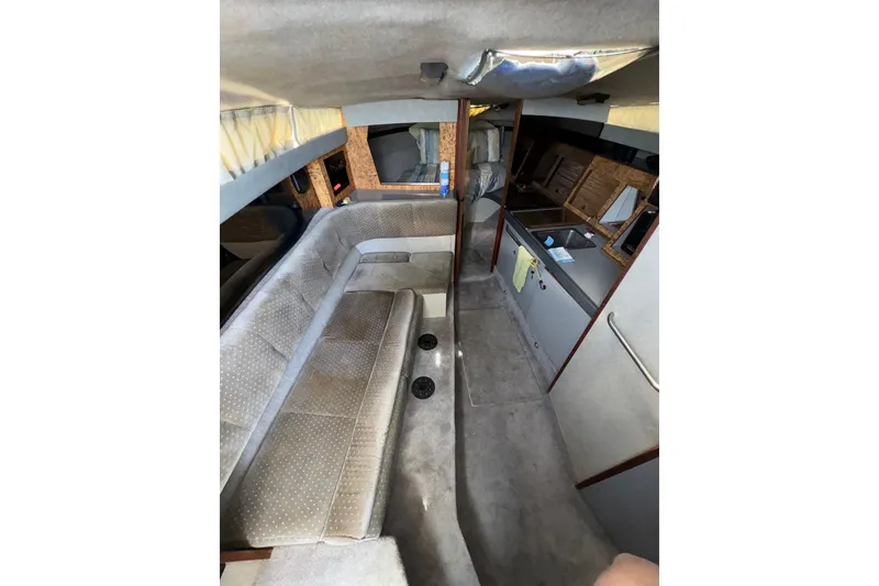 Slide: The Image of Interior of a 1985 Formula 28 PC boat with seating and kitchenette. - 10
