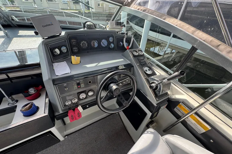 Slide: The Image of 1985 Formula 28 PC boat cockpit with steering wheel, gauges, and Garmin navigation system. - 3