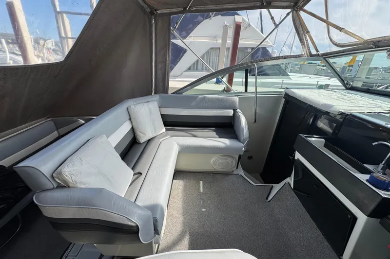 Slide: The Image of Interior of a 1985 Formula 28 PC boat with cushioned seating and helm. - 4