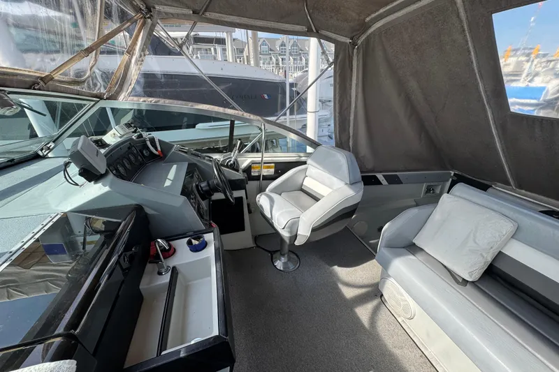 Slide: The Image of 1985 Formula 28 PC boat interior with helm, seating, and dashboard controls. - 6