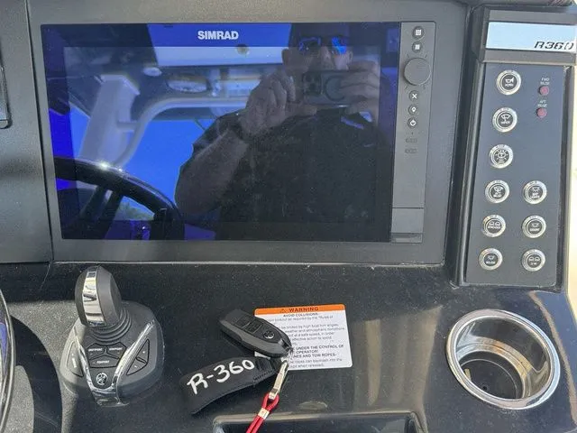 Slide: The Image of 2026 Robalo R360 Center Console dashboard with Simrad display and controls. - 14