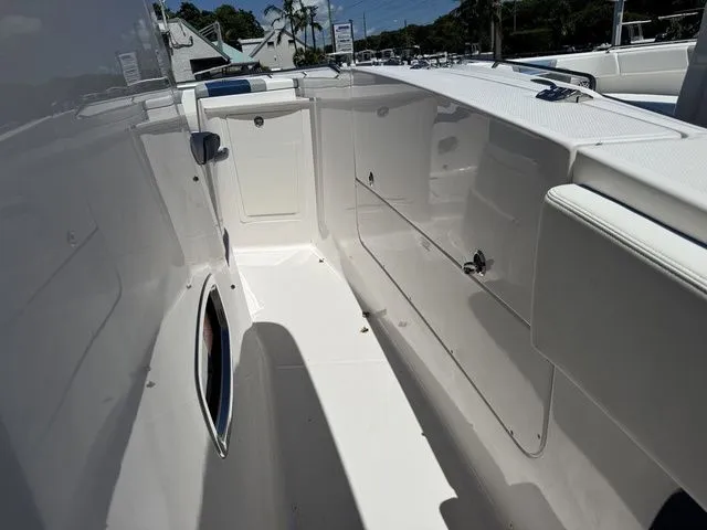 Slide: The Image of 2026 Robalo R360 Center Console boat interior with sleek white design and storage compartments. - 24