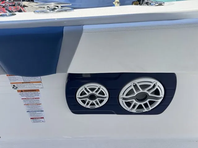 Slide: The Image of 2026 Robalo R360 Center Console boat speakers and warning labels on the side panel. - 26