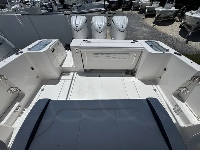 Slide: The Image of 2026 Robalo R360 Center Console boat with triple engines, spacious deck, and seating area. - 8