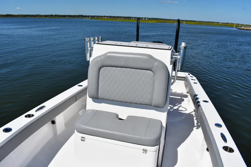 Slide: The Image of Open storage compartment on 2023 Xplor X24 boat, featuring dual batteries and speakers. - 10