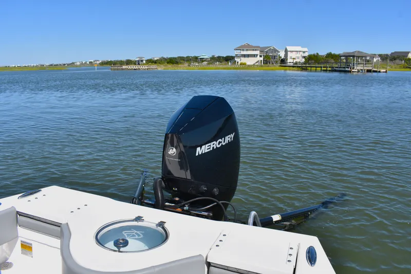 Slide: The Image of 2023 Xplor X24 boat with open storage compartment and cushioned seating. - 13