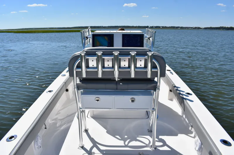 Slide: The Image of 2023 Xplor X24 boat dashboard with dual screens on a calm lake. - 16