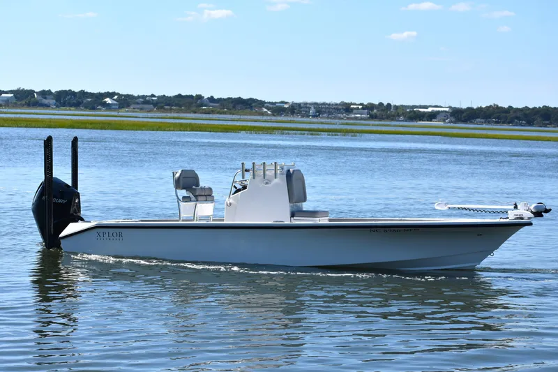 Slide: The Image of 2023 Xplor X24 boat on calm water with scenic background. - 6
