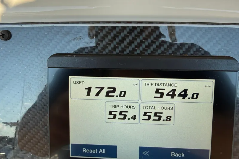 Slide: The Image of 2024 Grady-White Fisherman 216 boat interior at marina, showcasing helm and seating. - 12